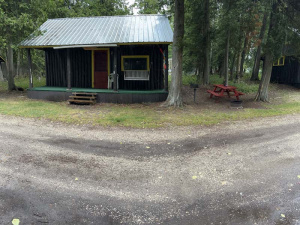 Dirt path in front of a small cabin